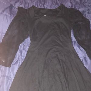 Large black dress with see through sleeves. Fit and flare.
